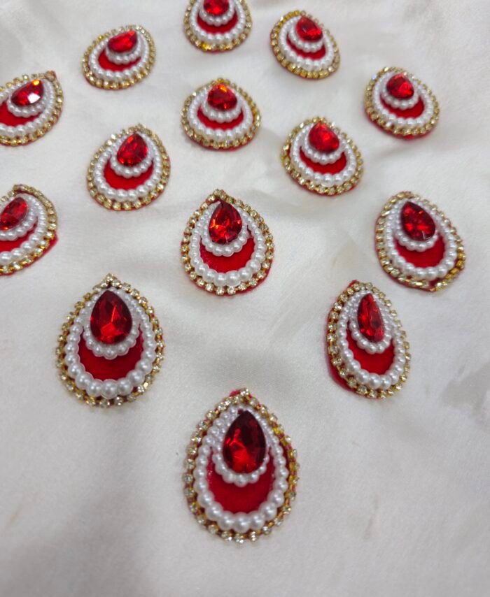 Red teardrop pearl and crystal embellishment charms with golden rhinestone border for DIY crafts and resin art.