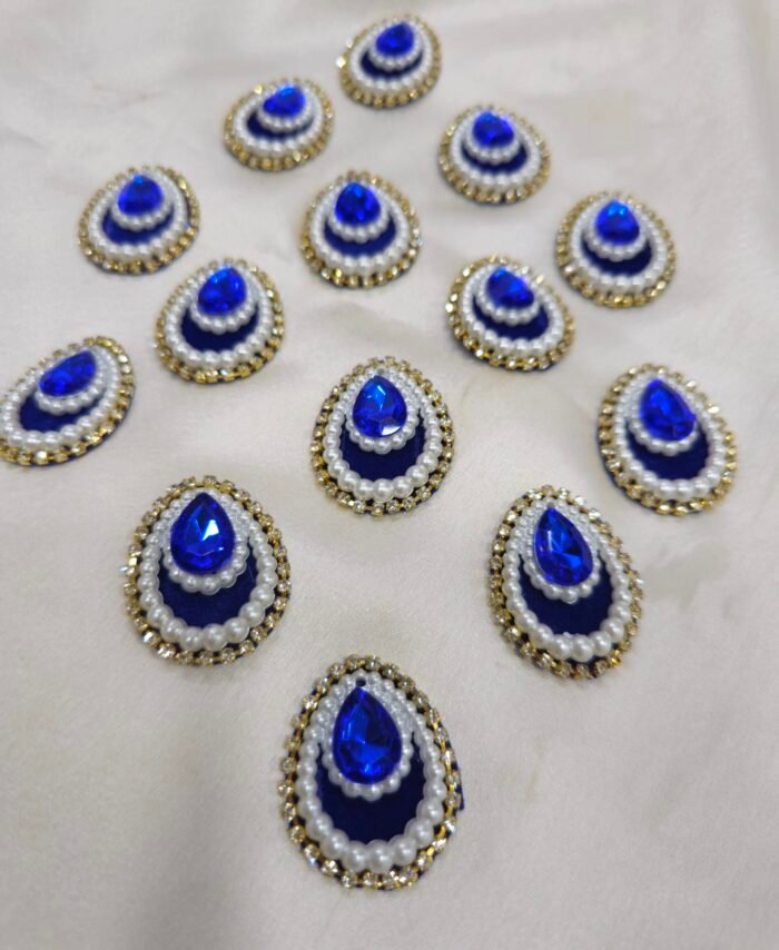 Blue teardrop pearl and crystal embellishment charms with golden rhinestone border for DIY crafts and resin art.