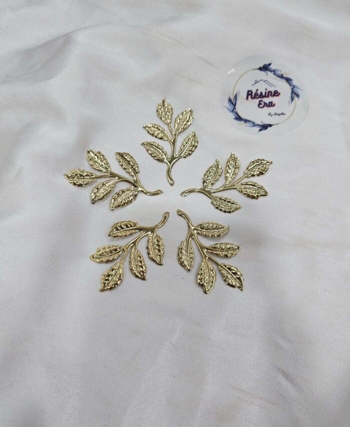 Gold metal leaf branch charm with detailed textured leaves placed on a white background.