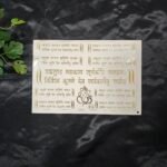 Gold embossed Vakratunda Mahakaya mantra sticker sheet with Sanskrit text and Ganesha symbol on a white background.