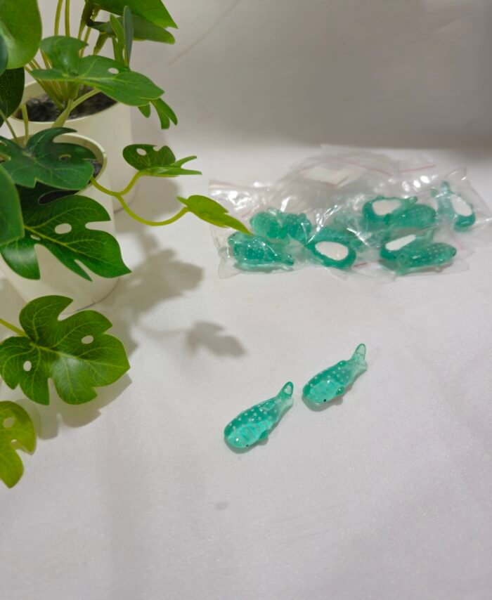 Miniature fish charms for resin art and jewellery making on a white background