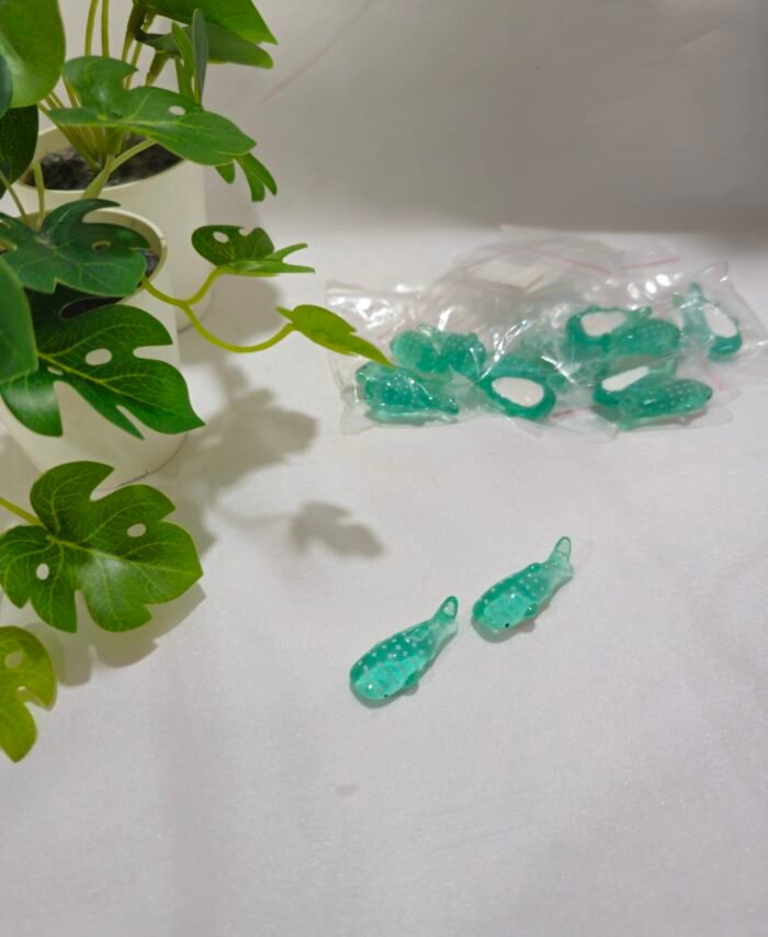 Miniature fish charms for resin art and jewellery making on a white background