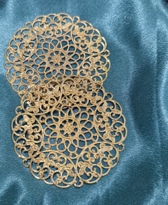 Golden round filigree metal charm with floral mandala design