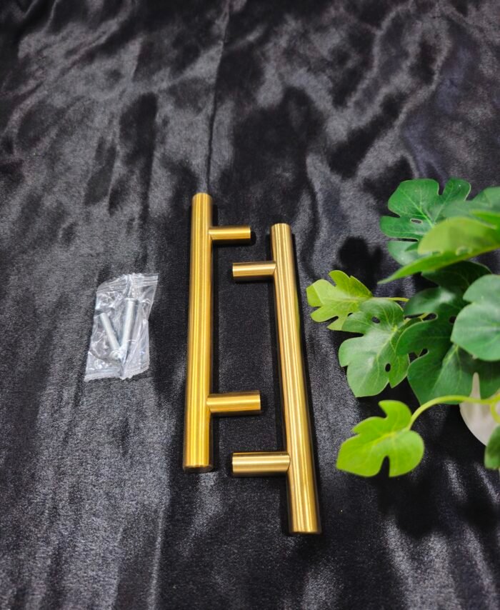 Gold 6 inch tray handle with screws placed on a black fabric background