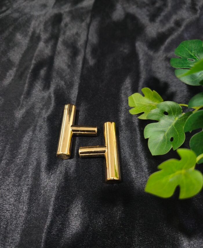 Gold T-shaped tray handle placed on a black fabric background for resin tray and cake stand use