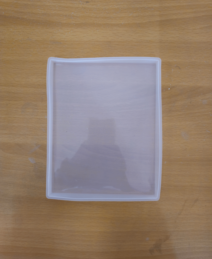 “Rectangle tiles silicone resin mould placed on a wooden surface.”