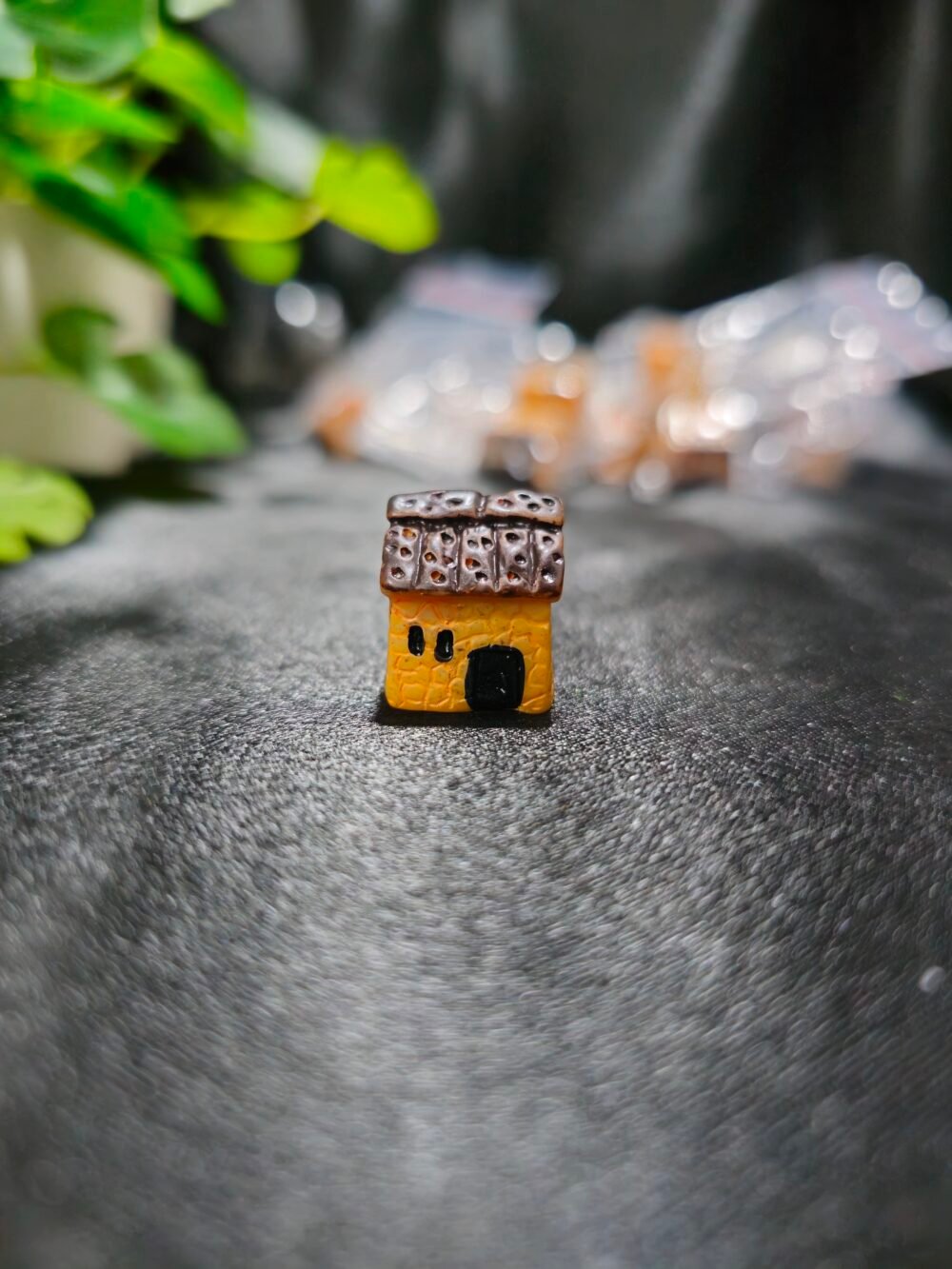 Handcrafted miniature hut with textured roof and rustic design used for resin art and miniature decoration