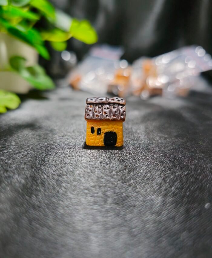 Handcrafted miniature hut with textured roof and rustic design used for resin art and miniature decoration