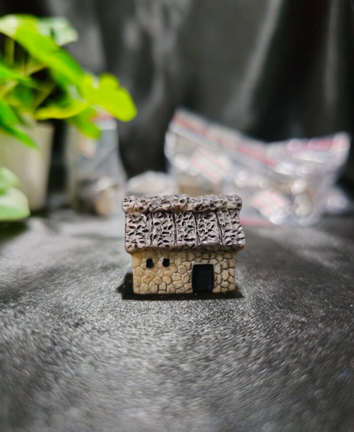 Handcrafted miniature hut with textured roof and rustic design used for resin art and miniature decoration