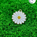 Decorative craft Daisy charms for resin art and jewellery making are displayed on a soft background