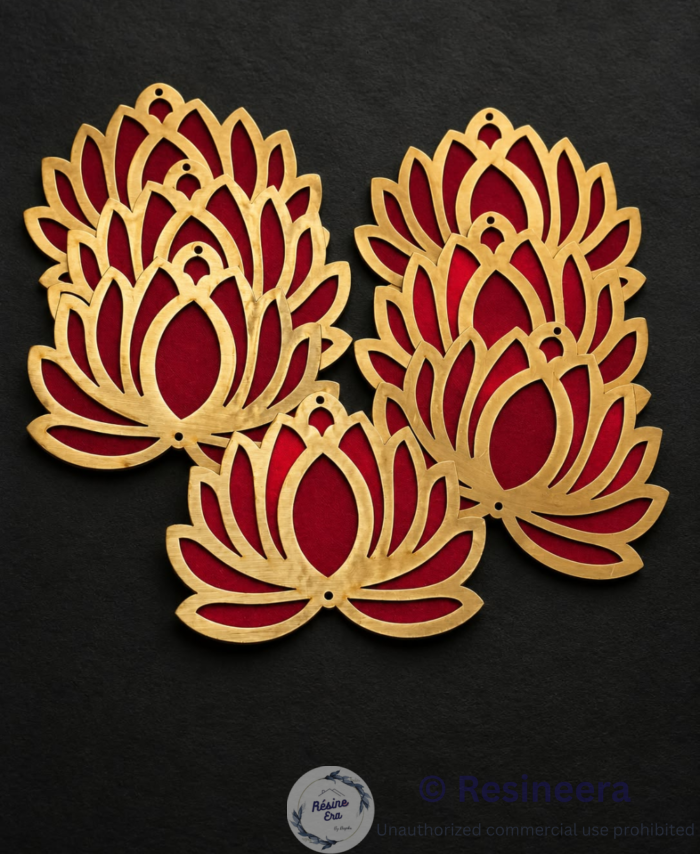 A Red and metallic acrylic lotus-shaped décor piece placed on a soft fabric background.