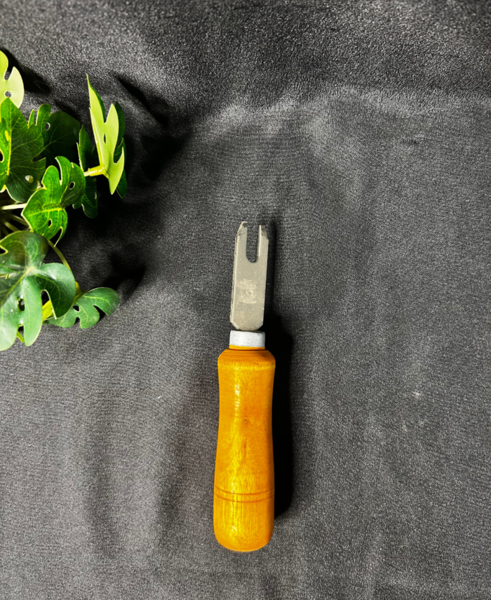 Wooden handle resin art tool with a metal fork tip used for detailed craft and resin work