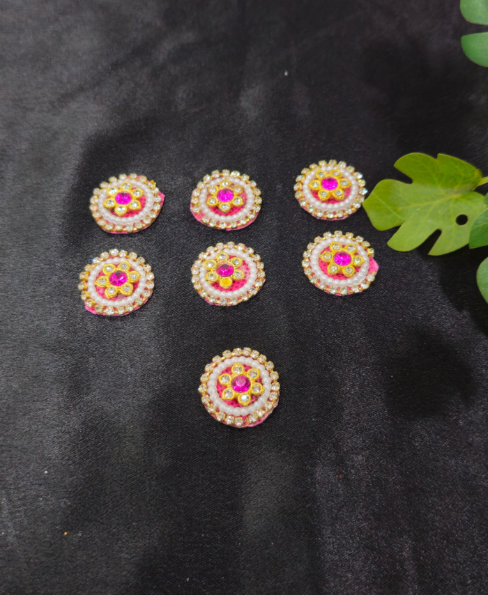 floral kundan round embellishments with pearl and crystal detailing on a black background