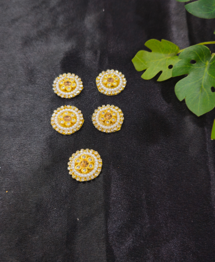 floral kundan round embellishments with pearl and crystal detailing on a black background