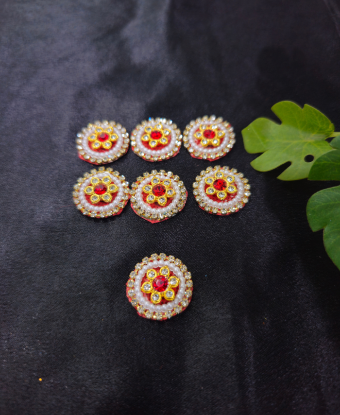 floral kundan round embellishments with pearl and crystal detailing on a black background