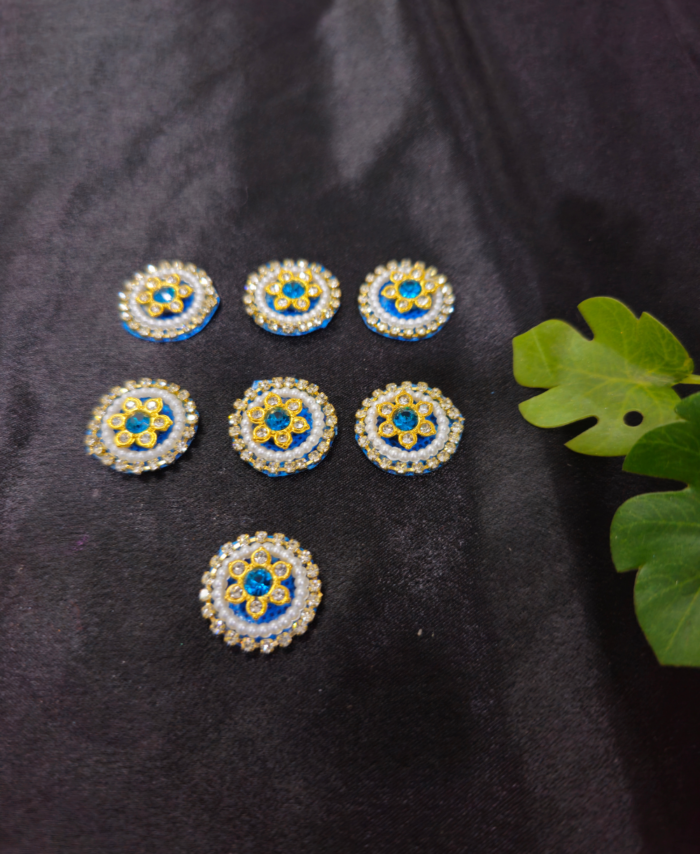 floral kundan round embellishments with pearl and crystal detailing on a black background