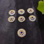 floral kundan round embellishments with pearl and crystal detailing on a black background