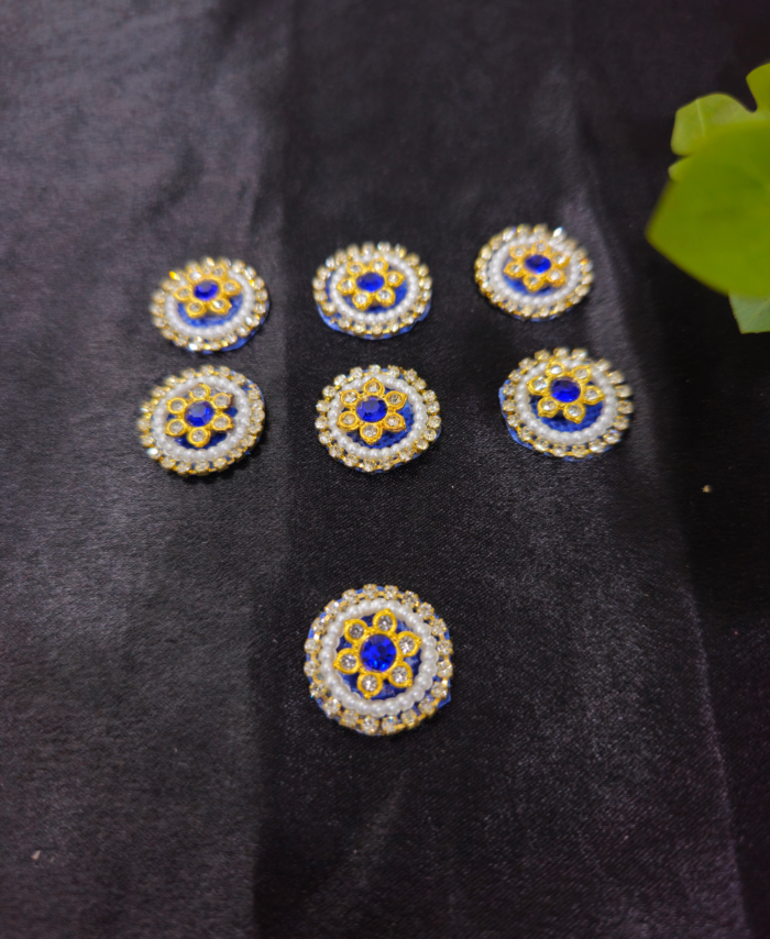 floral kundan round embellishments with pearl and crystal detailing on a black background