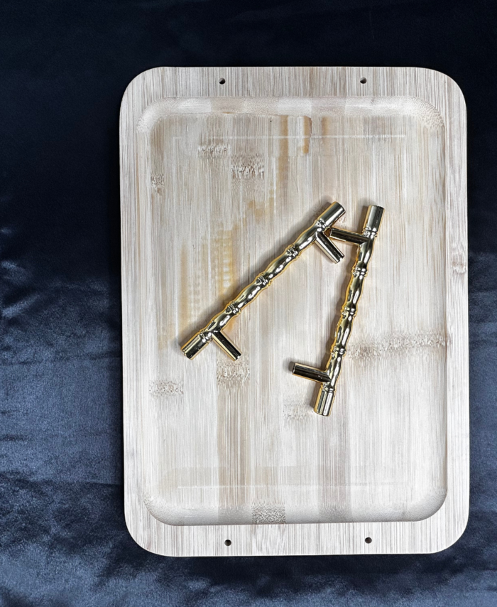 Wooden tray with metal handles and screws placed on a wooden base for DIY resin art and home décor projects