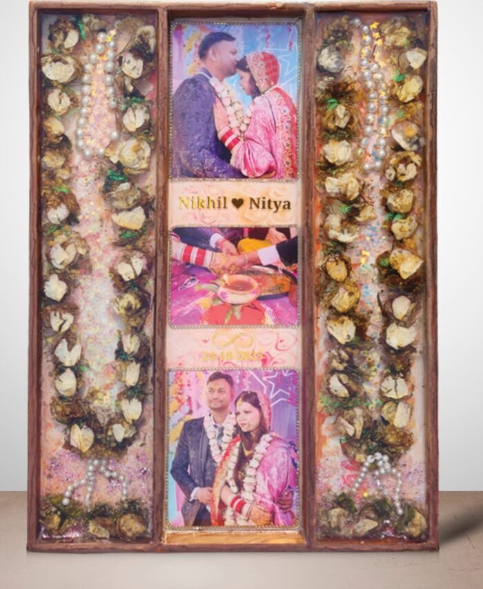 3-column full varmala preservation frame with preserved wedding garland flowers, couple photos, pearls, and decorative elements set in epoxy resin wooden wall frame.
