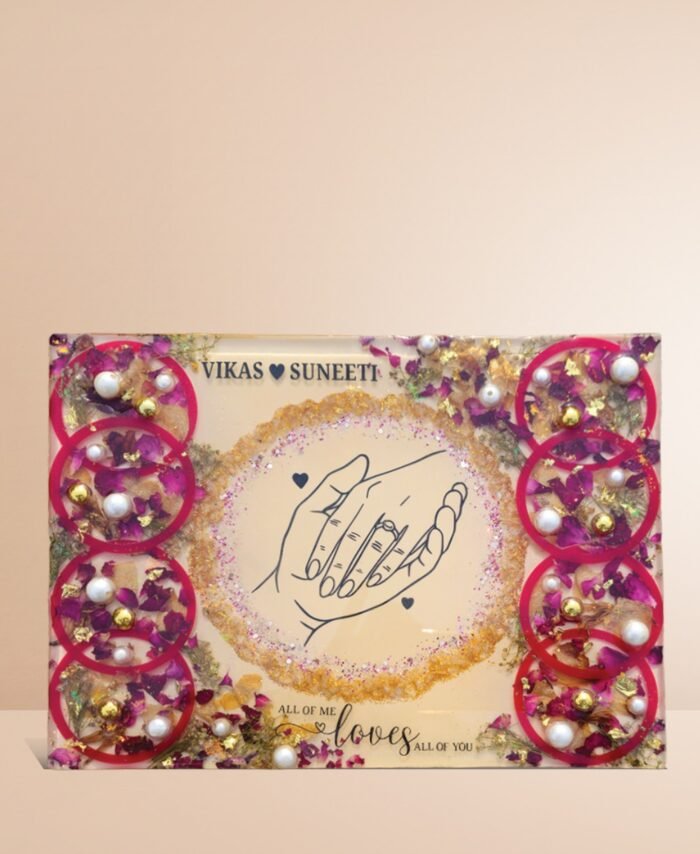 Customized floral preservation frame with preserved wedding flowers, pearls, and gold flakes in resin display