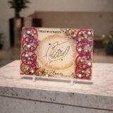 Customized floral preservation frame with preserved wedding flowers, pearls, and gold flakes in resin display