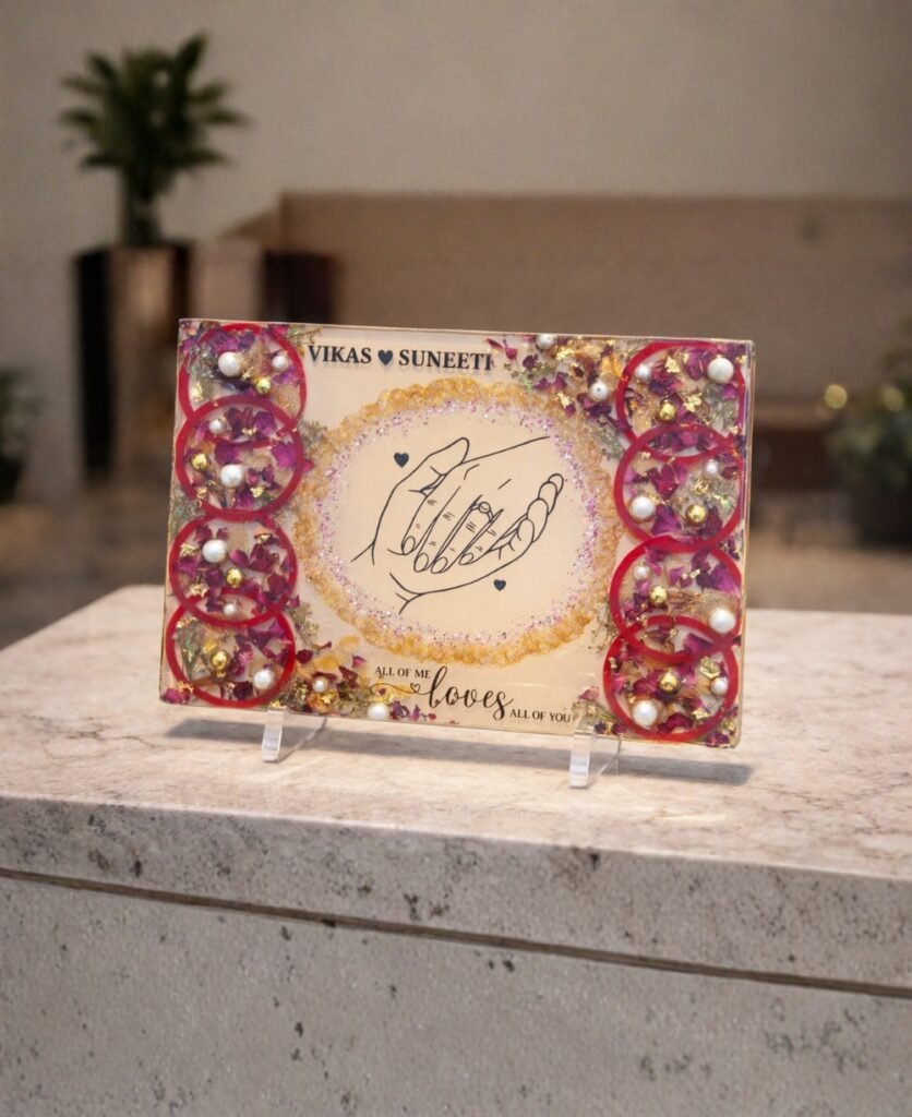 Customized floral preservation frame with preserved wedding flowers, pearls, and gold flakes in resin display