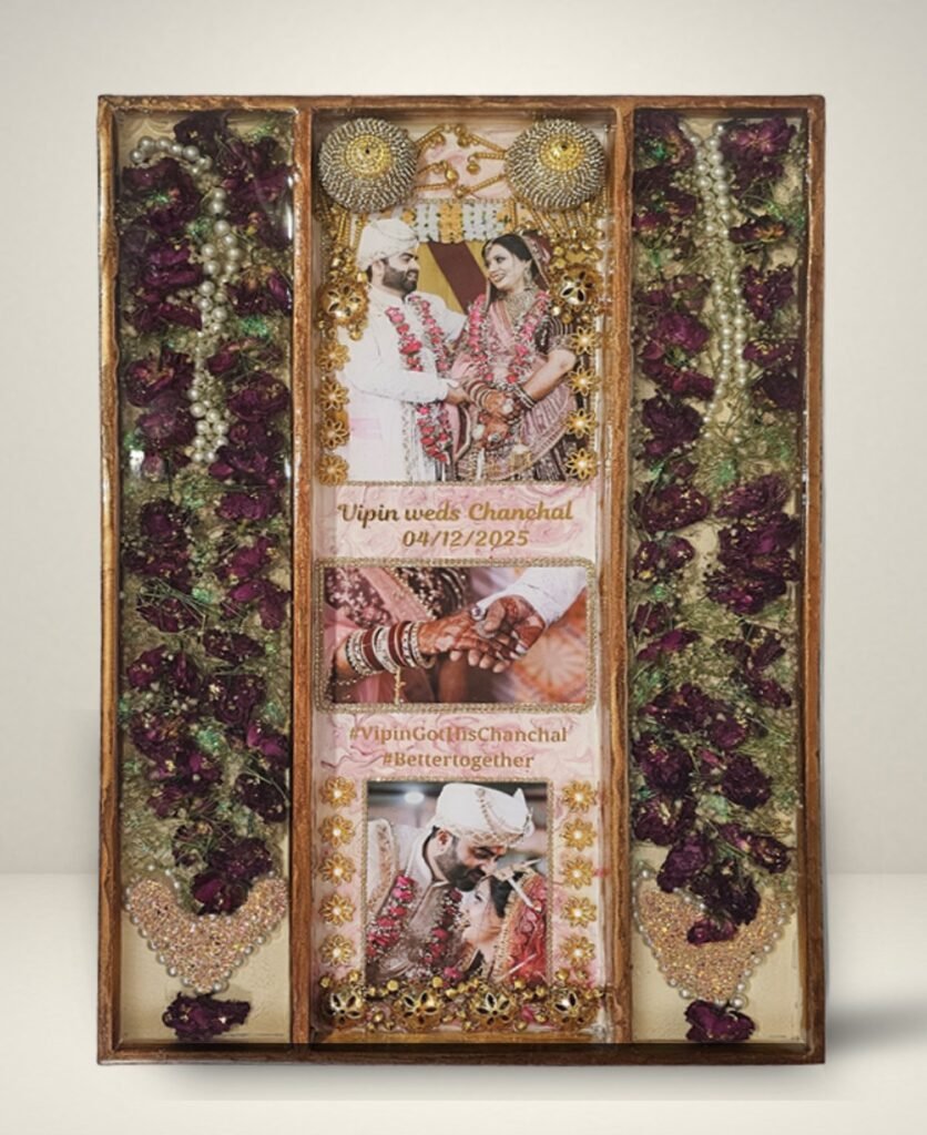 3 columns full varmala preservation frame with complete wedding garland preserved in epoxy resin, couple photos, pearls, and decorative elements in a wooden wall frame.