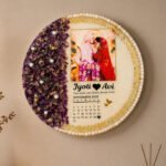 Round varmala resin frame with preserved wedding flowers, couple photo, calendar date, and pearl gold detailing