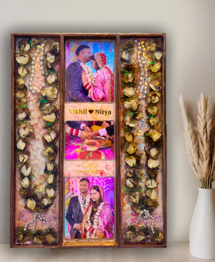 3-column full varmala preservation frame with preserved wedding garland flowers, couple photos, pearls, and decorative elements set in epoxy resin wooden wall frame.
