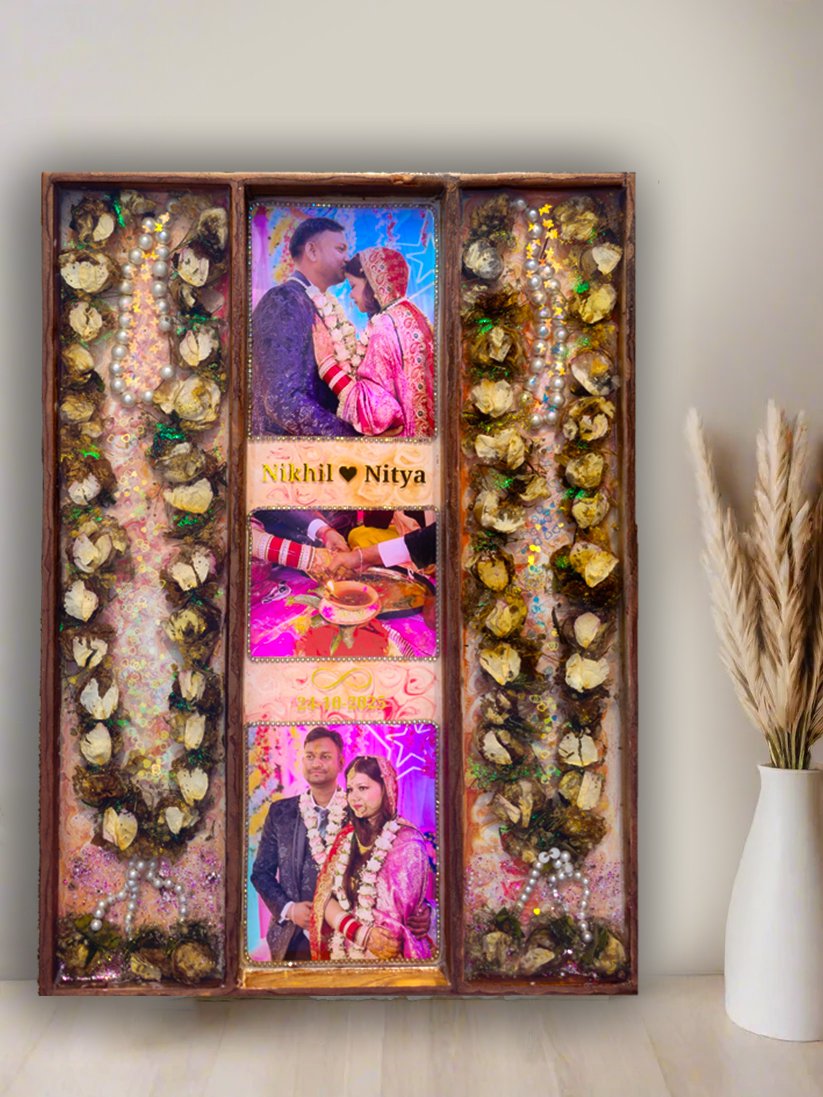 nitya 3-column full varmala preservation frame with preserved wedding garland flowers, couple photos, pearls, and decorative elements set in epoxy resin wooden wall frame.