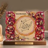 Customized floral preservation frame with preserved wedding flowers, pearls, and gold flakes in resin display
