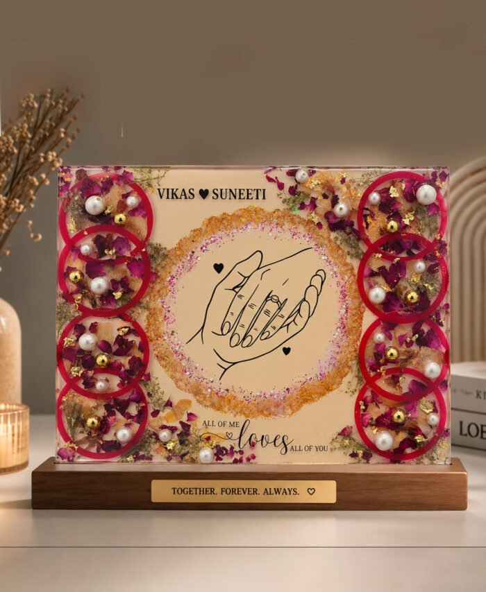 Customized floral preservation frame with preserved wedding flowers, pearls, and gold flakes in resin display