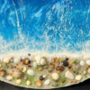 Round ocean resin wall art with blue waves, sandy beach texture, and glossy finish