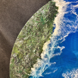 Round ocean resin wall art with blue waves, sandy beach texture, and glossy finish
