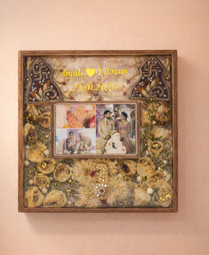 Customized wedding flower preservation frame with photos, golden dried flowers, names, and wedding date in resin