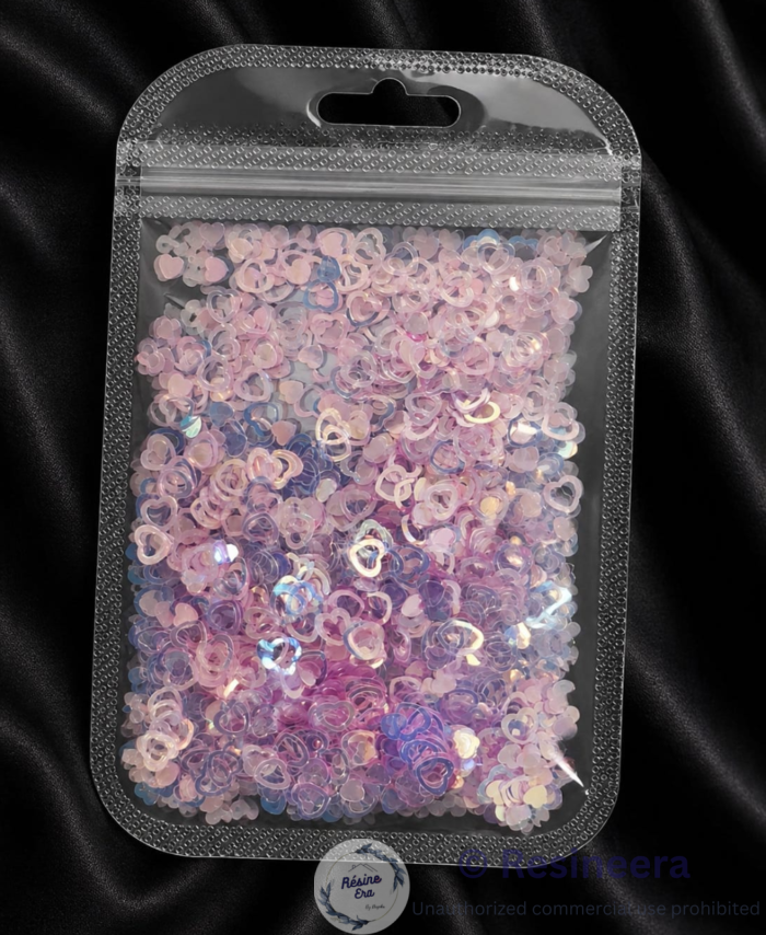 Holographic/Sequence Heart glitter flakes for resin art and craft decoration on a dark background