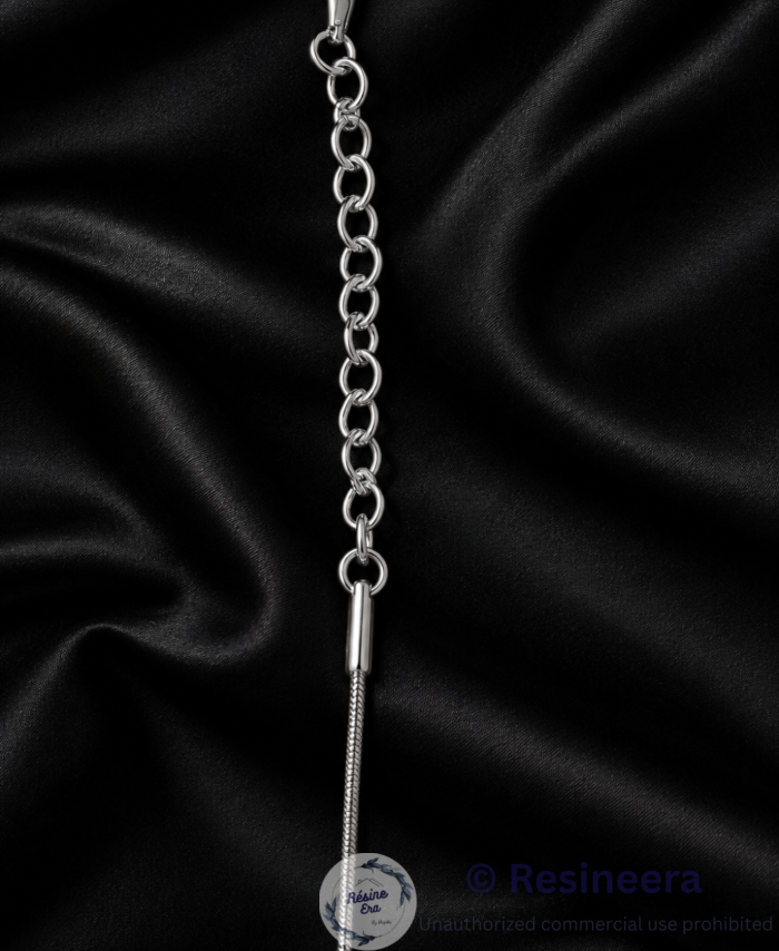 Silver anti-tarnish chain necklace with lobster clasp and extension chain on a beige background.