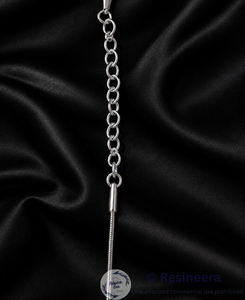 Silver anti-tarnish chain necklace with lobster clasp and extension chain on a beige background.