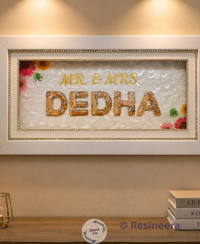 Varmala preservation frame with surname, preserved flowers, golden lettering, and white decorative frame