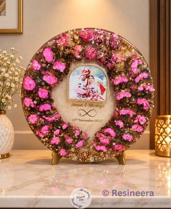 Round lotus and Varmala preservation frame with pink flowers, wedding photo, pearls, and golden decorative accents